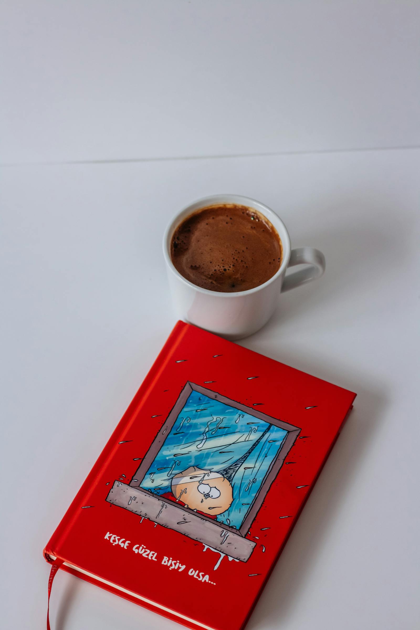 A close-up of a morning ritual: a notebook with handwritten notes, a steaming mug of herbal tea, a small bowl of almonds and a dried fig, eyeglasses, on linen.